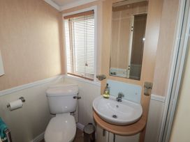 A bathroom with a sink and toilet at Rhosgranog Caravan in Llandeloy near Solva