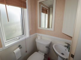 A bathroom with a toilet and sink at Rhosgranog Caravan Llandeloy near Solva