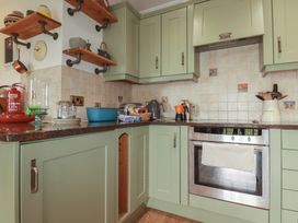 A kitchen with cabinets and appliances at Beachcombers Apt 11