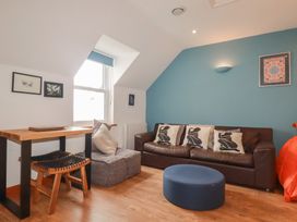 A living room with a sofa and table at Beachcombers Apt 11