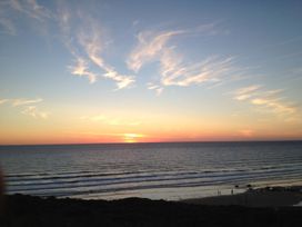 A beach scene during sunset at Beachcombers Apt 11 Watergate Bay near Newquay
