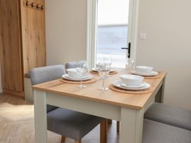 A dining room with a table set for meals at No.20 - The Oaks in Delamere