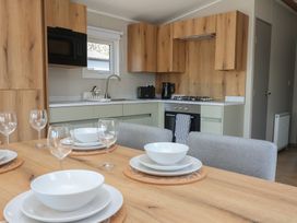 A kitchen with a dining table and chairs at No.20 - The Oaks in Delamere
