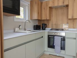 A kitchen with sink and appliances at No.20 - The Oaks Delamere