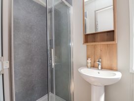 A bathroom with a shower and sink at No.20 - The Oaks, Delamere