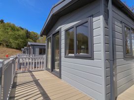 A balcony of a house with windows and wooden deck at No.20 - The Oaks, Delamere