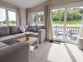 A living room with a sofa and a table at The Oaks 2 Bedrooms Delamere