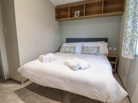 A bedroom with a bed and towels on it at The Oaks 2 Bedrooms in Delamere