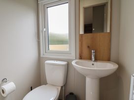 A bathroom with a toilet and sink at The Oaks 2 Bedrooms in Delamere