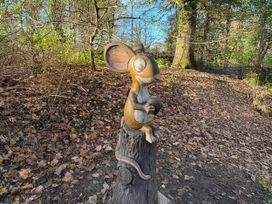 A wooden mouse sculpture on a path surrounded by trees at Ashberry 38 x 12 Two Bed (Pet Free), Northwich