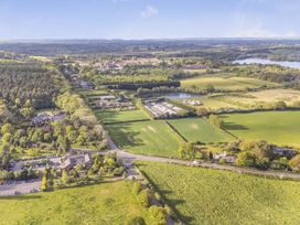 An aerial view of fields, trees, and houses at The Oaks 2 Bedrooms in Delamere