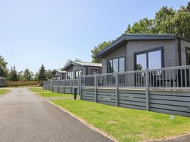 Outdoor area with cabins and a walkway at The Oaks 2 Bedrooms Delamere