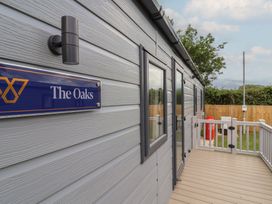 An exterior view of The Oaks with a deck at The Oaks 2 Bedrooms in Delamere