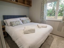 A bedroom with a double bed and window at The Oaks 2 Bedrooms Delamere