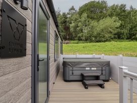 An outdoor area with a hot tub at Cedar Lodge 2 Bedrooms with hot tub in Delamere