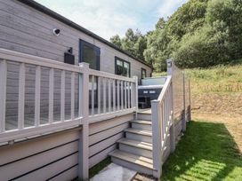 An outdoor area with steps leading to a hot tub at Cedar Lodge 2 Bedrooms with hot tub, Delamere