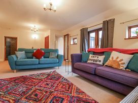 A living room with sofas and a rug at The Pantiles in Banham