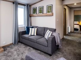 A living room with a sofa and a window at No 10 Linmere Lodge Escape in Northwich