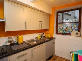A kitchen with cabinets and sink at Frida's Cottage in Whitby