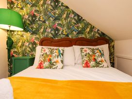 A bedroom with a bed and lamp at Frida's Cottage in Whitby