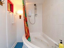 A bathroom with a shower and bathtub at Frida's Cottage in Whitby
