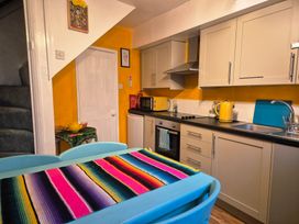 A kitchen with a table and chairs at Frida's Cottage in Whitby