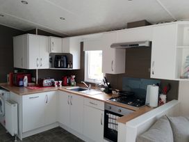 A kitchen with appliances and cabinets at 48 Woodland View in Lymington