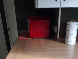 A kitchen with a microwave and canisters at 48 Woodland View Lymington