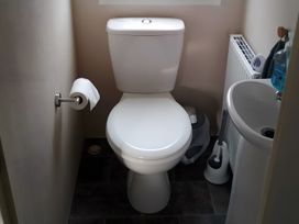 A bathroom with a toilet and sink at 48 Woodland View in Lymington