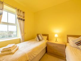 A bedroom with twin beds and a nightstand at Bank House Cottage in Lancaster