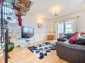 A living room with a sofa and television at Bank House Cottage Glasson Dock