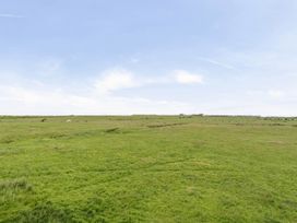 A landscape with grass and hills at Bank House Cottage Glasson Dock