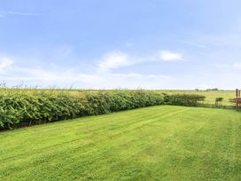 A garden with grass and hedges at Bank House Cottage Glasson Dock