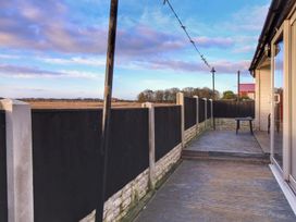 An outdoor area with wooden decking and a table at Sea View Retreat in Bridlington