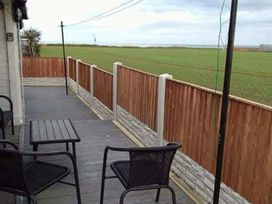 An outdoor space with a table and chairs at Sea View Retreat in Bridlington
