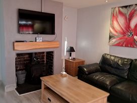 A living room with a television and a sofa at Sea View Retreat in Bridlington