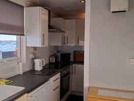 A kitchen with appliances and cabinets at Sea View Retreat in Bridlington