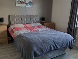 A bedroom with a bed and bedside tables at Sea View Retreat in Bridlington