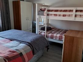 A bedroom with a double bed and bunk bed at Sea View Retreat in Bridlington