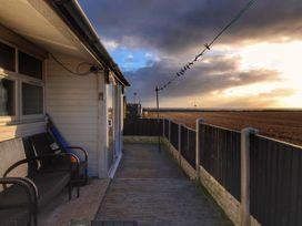 An outdoor area with decking and chairs at Sea View Retreat in Bridlington