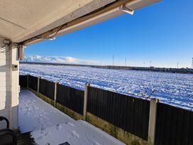 A view of a snowy field with a fence at Sea View Retreat in Bridlington