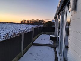 An outdoor area with snow and a fence at Sea View Retreat in Bridlington