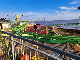 A roller coaster track at an amusement park by the sea at Sea View Retreat in Bridlington