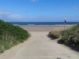 A pathway leading to the ocean at Sea View Retreat in Bridlington