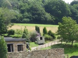 An outdoor view including a hut and trees at Cosy Shepherd’s Hut Longhope