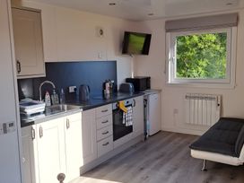 A kitchenette with a sink and appliances at The Posh Bothy 2 Roy Bridge