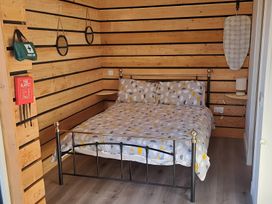 A bedroom with a bed and first aid kit at The Posh Bothy 2 Roy Bridge