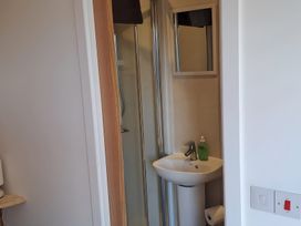 A bathroom with a shower and sink at The Posh Bothy 2 in Roy Bridge