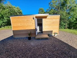 A cabin with a door and steps at The Posh Bothy 2 in Roy Bridge