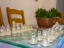 A chessboard with pieces and a plant pot at Pityme-Not Wadebridge